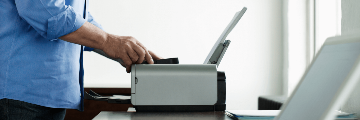 A man operating his multifunction printer