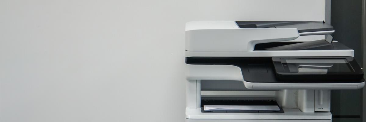 Single printer against a white wall