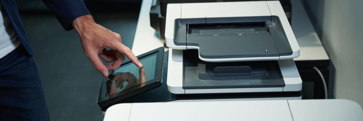 person using printer, adjusting touchscreen settings